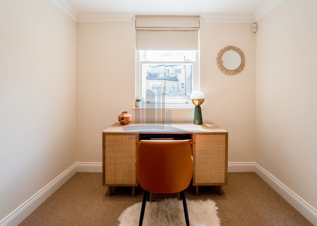 home office in warm colours with one desk and chair remodelled by loft conversion company london