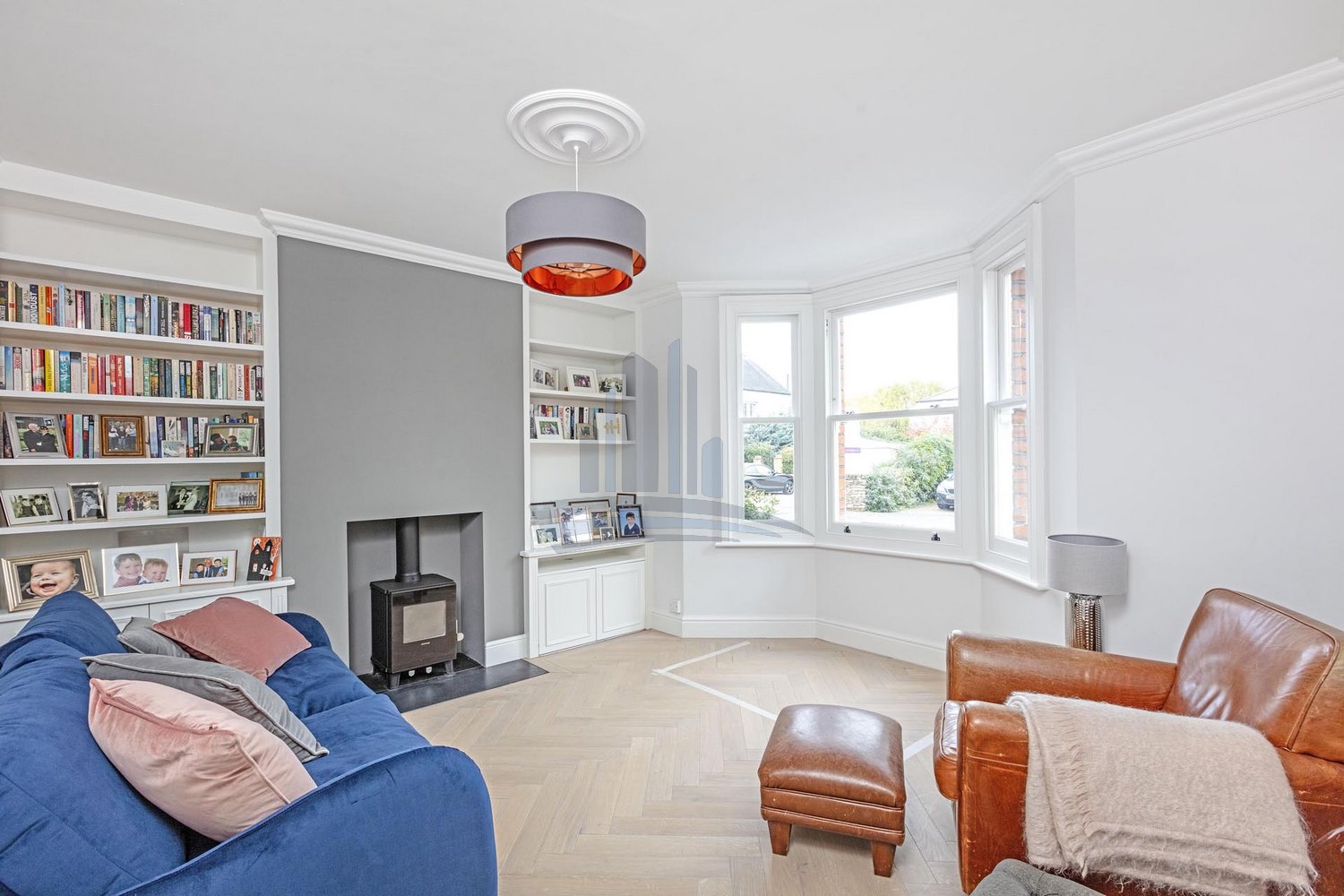 house interior in white and gray colours and with books on shelves after renovation by loft conversion company london