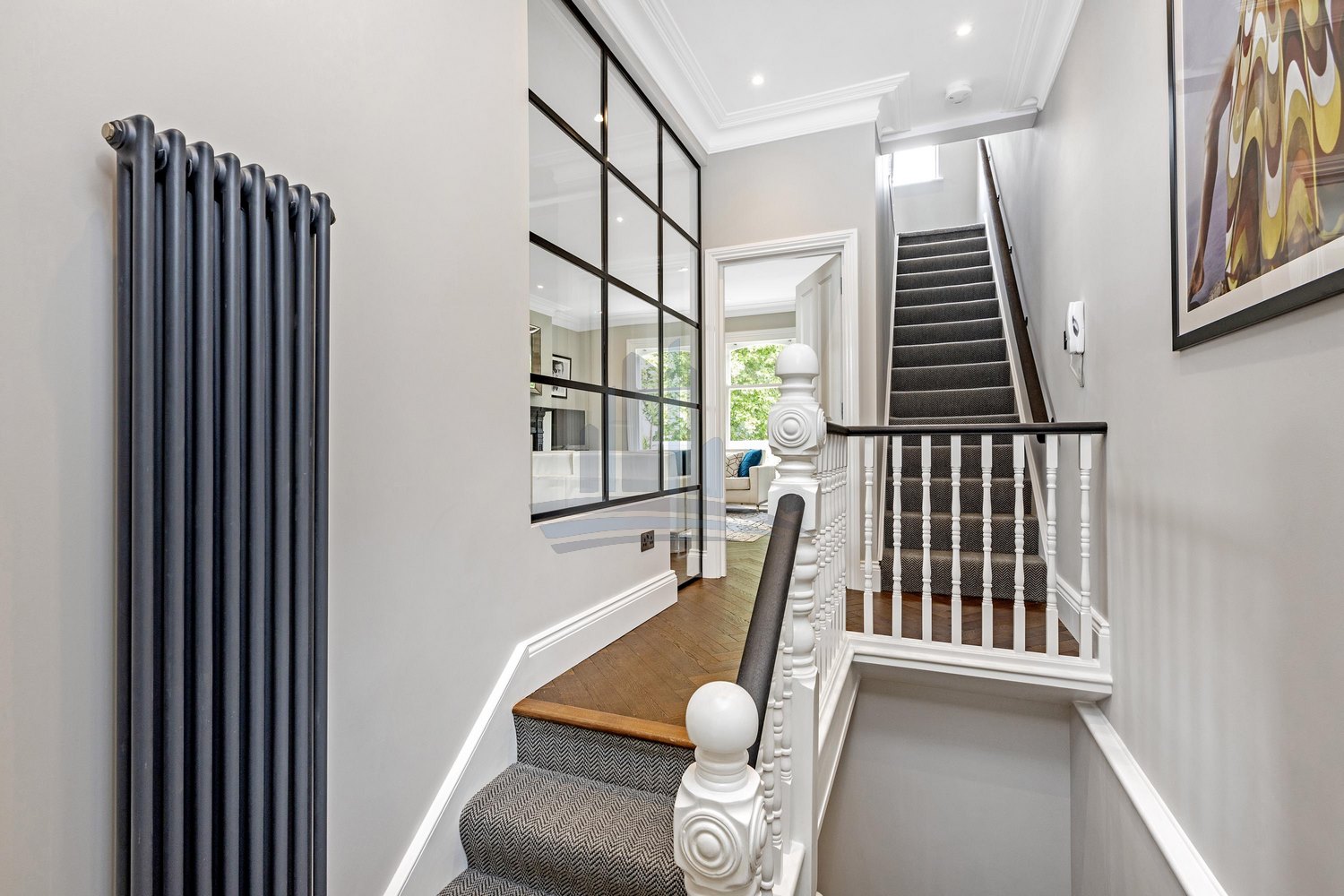 corridor with stairs in wooden, white and balck colours after converstion by loft conversion company london