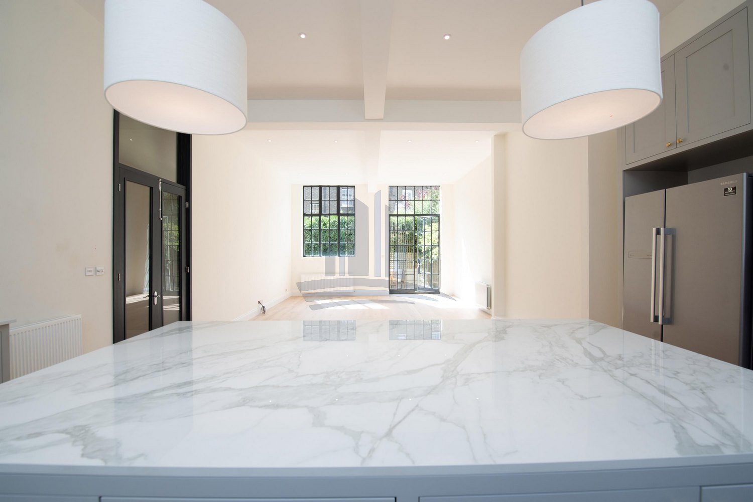 kitchen with large quartz countertop and open space after remodeling by loft conversion london